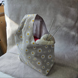 Floral pattern bag with grey interior on a neutral background